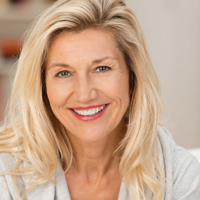 A smiling woman with long blonde hair